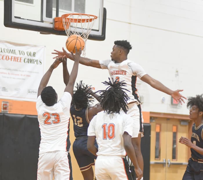 Leesburg's Camerin James (2) tries to block Wekiva's Abiah Charles (12) while Leesburg's Wilton Jean-Pierre (23) and Nigel Harris (10) assist on defense in the first half.
